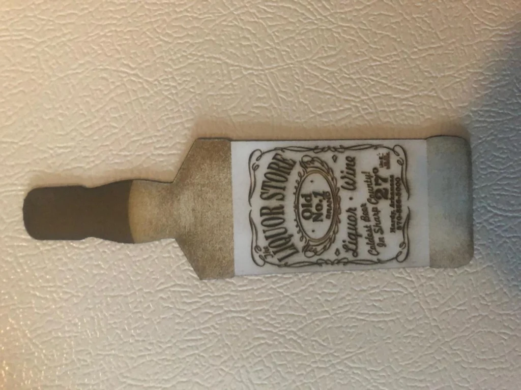 Wooden bottle magnet on refrigerator door