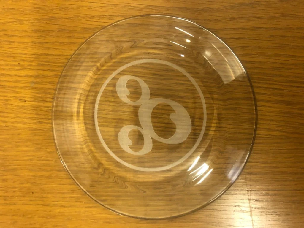 Glass plate with etched circular design on table