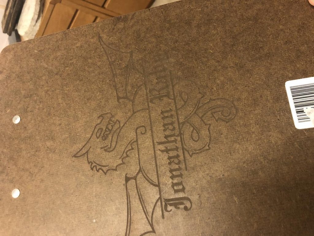 Wooden surface with dragon design and text