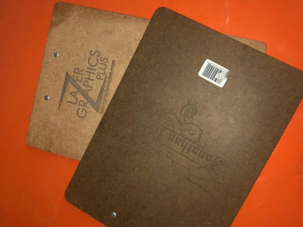 Two brown clipboards on an orange background.