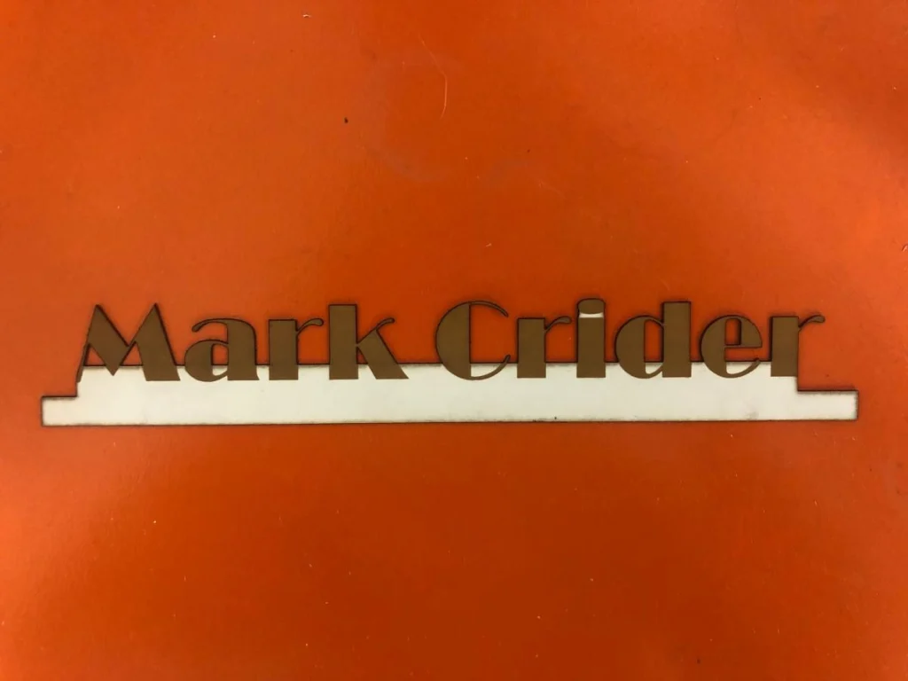 Laser-cut name sign on orange background