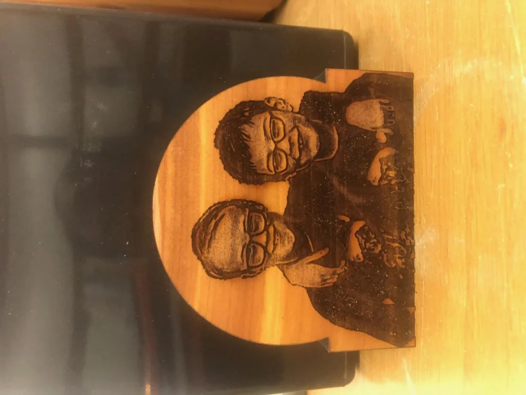 Engraved wooden plaque with two people portrait